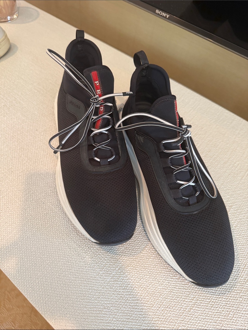 Prada Black Sneakers with White Sole and Red Tongue Detail